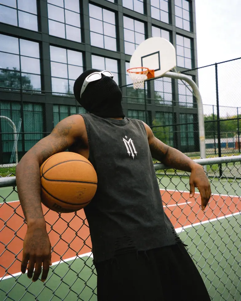 MIROSS washed sleeveless logo tee — basketball court fence editorial
