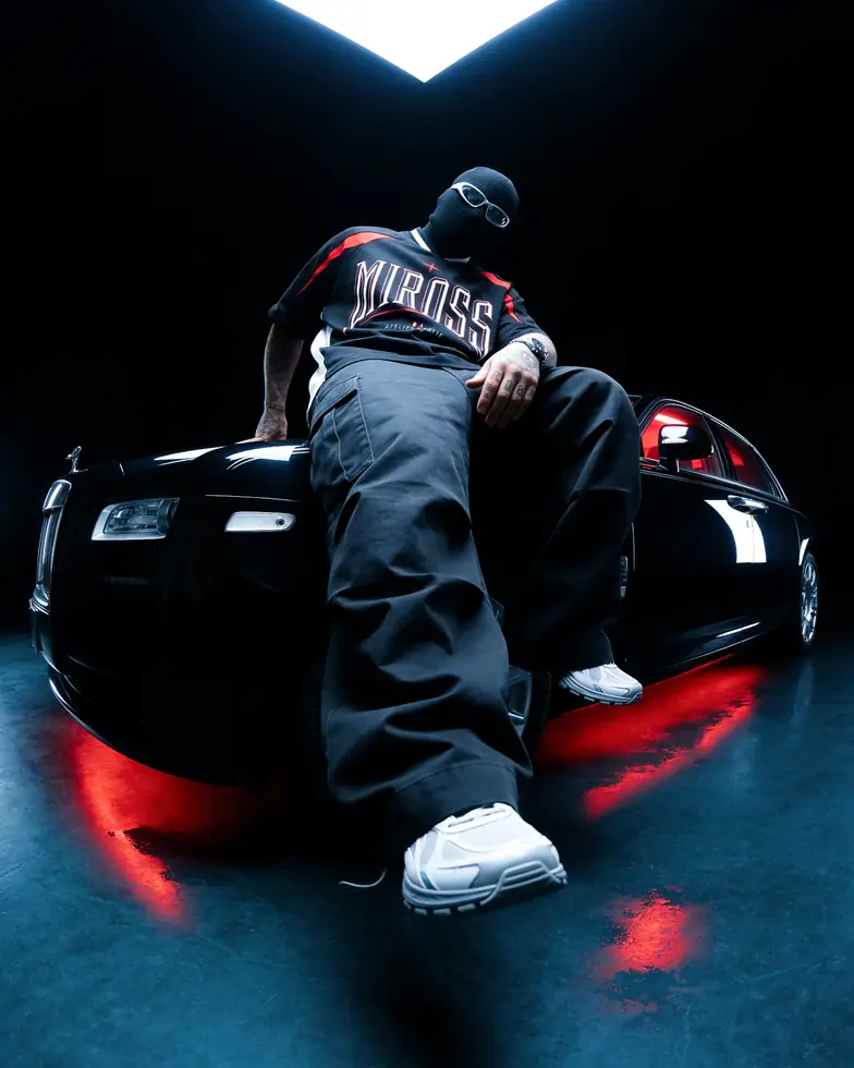 MIROSS baseball jersey — red-lit luxury automotive editorial